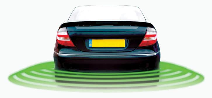 The back of a car with the car sensors in action collecting information for the driver