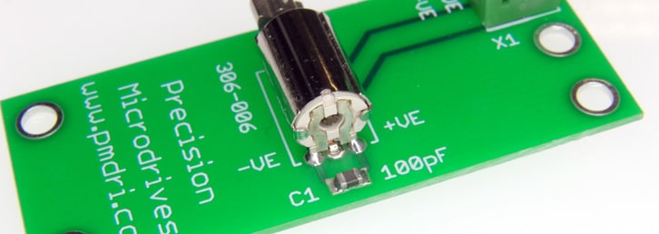 A vibration motor mounted to a PCB with a ceramic capacitor between the motor terminals