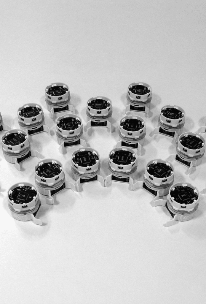 A group of swarm robots placed on a lab countertop