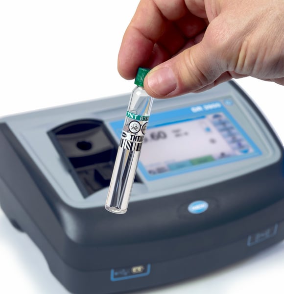 A portable desktop water analysis machine with a sample of water ready to be tested.