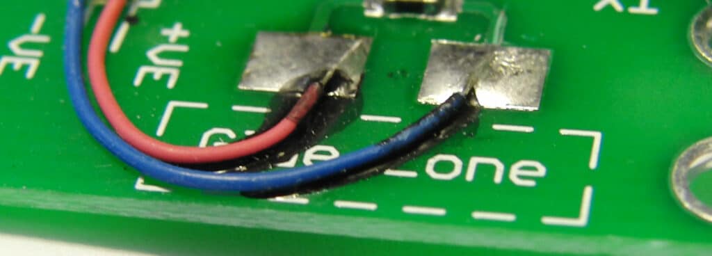 A close up of the leads being soldered to the pads on the PCB.