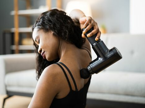 Woman using a massage gun