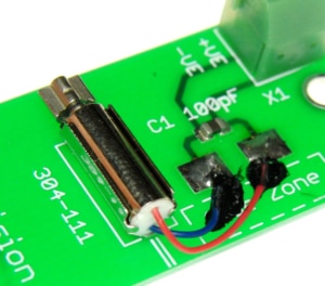 A vibration motor with flying leads mounted to a PCB 