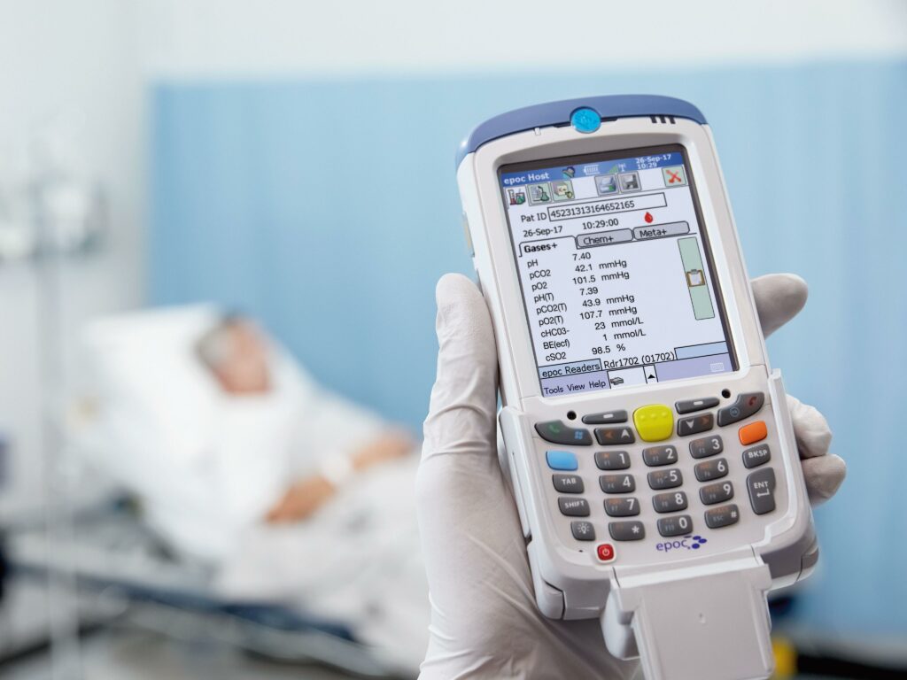 A blood gas testing device being used at a patients bedside.