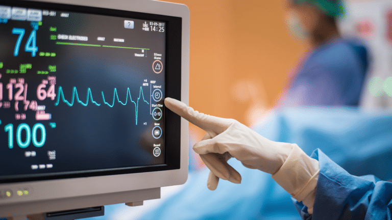 Touchscreen ECG monitor with the hand of a medical professional touching the screen